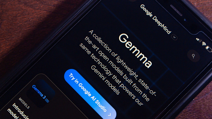 A smartphone screen displays information about Gemini, an open-source AI model by Google DeepMind.